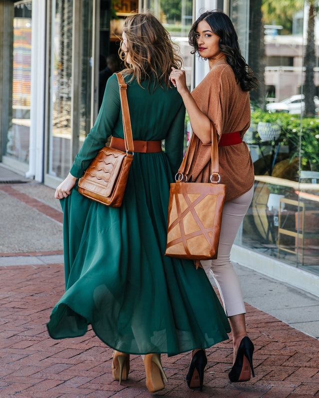 2 Ladies wearing bulletproof bags along the city street